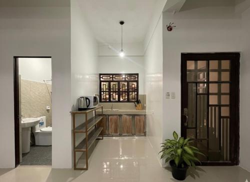 a bathroom with a sink and a toilet and a tub at Aga's Transient House in Baguio