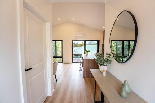 a living room with a mirror and a table at Moritz Hahndorf Boutique Guest House in Hahndorf