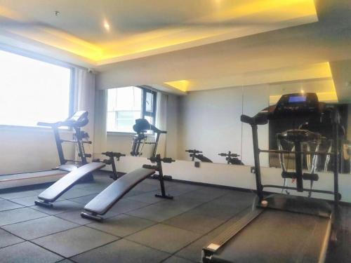 a gym with several tread machines in a room at Yanji Yanbian International Hotel in Yanji