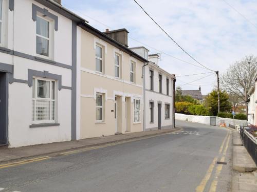 an empty street next to a white building at Bristol House in New Quay