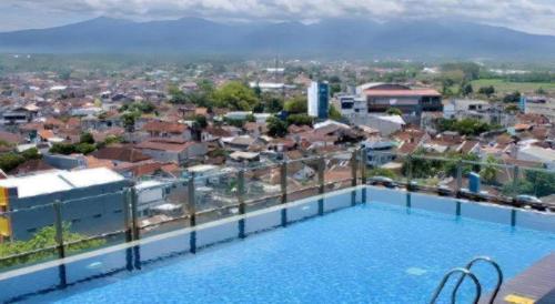 a view from the roof of a building with a swimming pool at Java Lotus Hotel Jember in Jember