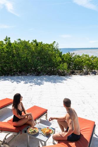 a man and a woman sitting on the beach at Grand Hyatt Tampa Bay in Tampa