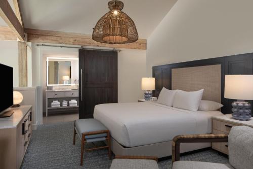 a bedroom with a large white bed and a television at Grand Hyatt Tampa Bay in Tampa