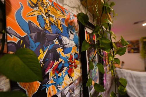 a painting of overwatchauts is next to a plant at Luxe Cosy Room in Beechboro in Perth