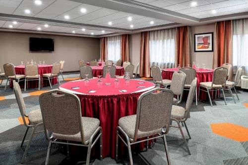 a conference room with tables and chairs with red table cloth at Four Points by Sheraton Barrie in Barrie