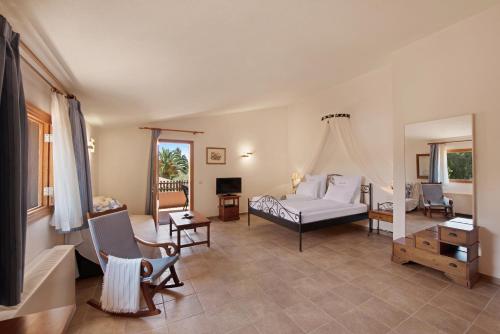 a bedroom with a bed and a living room at Ses Rotes Velles - Petit Hotel in Ses Salines