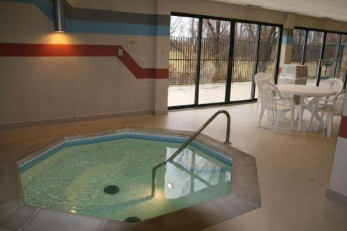 a jacuzzi tub in a room with a table at Hampton Inn Mt. Vernon in Webster Hill Estates