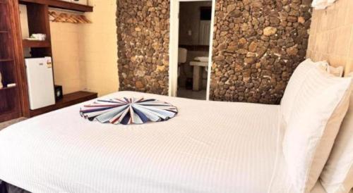 a white bed with a pillow on top of it at Orator Hotel in Apia