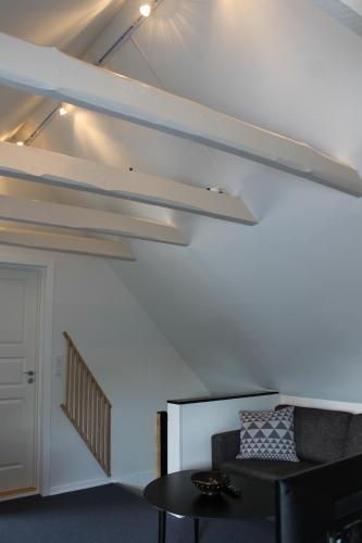 a living room with a couch and a table at Amalie Bed and Breakfast & Apartments in Odense