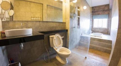 a bathroom with a toilet and a sink and a shower at Maximize Brand New Hostel Udonthani in Udon Thani