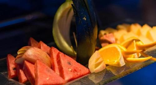 a pile of fruit being cut up with a knife at Chambery Hotel in Zhuhai