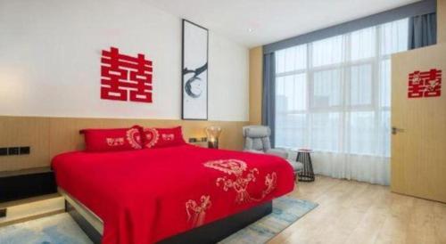 a bedroom with a red bed and a large window at Fairfield by Marriott Baoding High-Tech Zone in Baoding