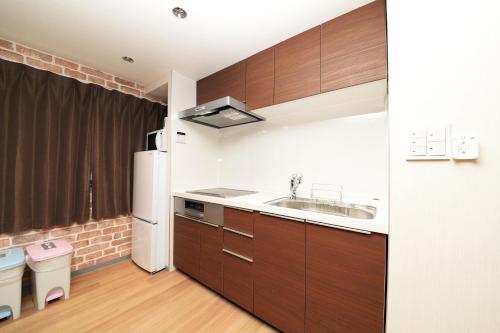 a kitchen with a sink and a refrigerator at Shinjuku NY House 2 in Tokyo