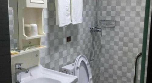 a bathroom with a toilet and a sink at Jun Hotel Jiangsu Nanjing Gulou District Gupinggang in Nanjing