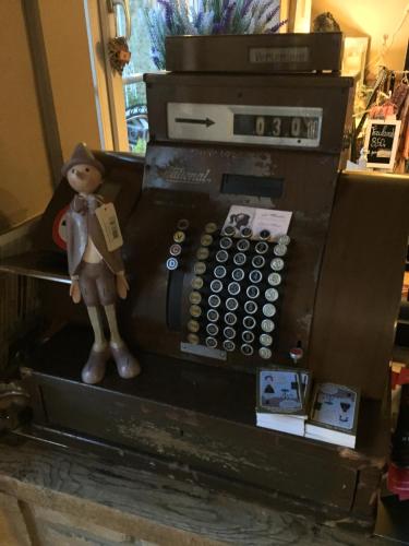 a toy doll is standing next to an old telephone at Le Relais de Chassepierre in Chassepierre