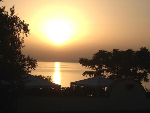 a sunset over the water with the sun setting at Villa Malandrino Guest House in Agropoli