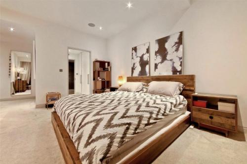 a large bedroom with a large bed with a zebraandan at Nest Penthouse in London