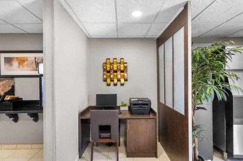 an office with a desk with a computer on a wall at Microtel Inn & Suites By Wyndham Conway in Conway