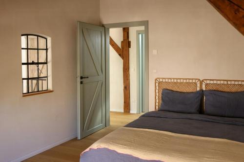 a bedroom with a bed and an open door at Idyllic Hideaway In The Countryside in Marienwerder