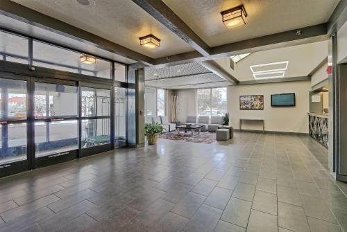 an empty lobby with a view of a living room at Ramada by Wyndham Albuquerque Midtown in Albuquerque