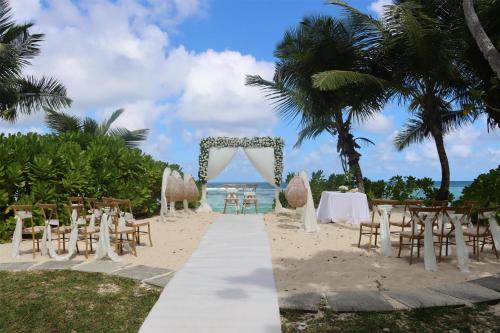 a wedding ceremony on the beach at the resort at Kempinski Seychelles Resort in Baie Lazare Mahé