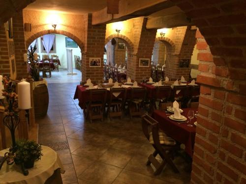 a restaurant with tables and chairs and a brick wall at B&B Kolarić in Jastrebarsko