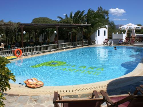 a swimming pool at a resort with people in it at Plaka Hotel I in Plaka