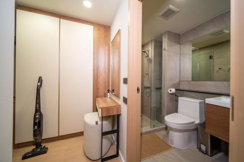 a bathroom with a toilet and a shower and a sink at 2Bdr Cozy Apartment in heart of BangTao in Ban Thalat Choeng Thale