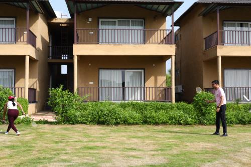 two people playing frisbee in front of a building at Sajjan Jawai Chapter by Arow Hospitality in Mori Bera
