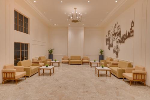 a waiting room with couches and tables at Lemon Tree Hotel Morbi 