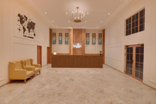 a large waiting room with a couch and chairs at Lemon Tree Hotel Morbi 