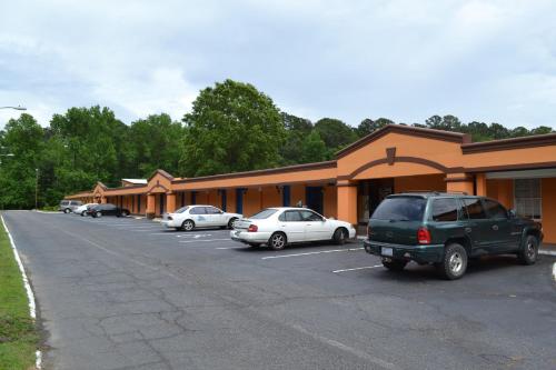 a building with cars parked in a parking lot at Americas Best Value Inn Smithfield in Smithfield