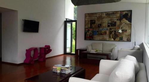 a living room with a couch and a table at VillaTel Salse in Bandung