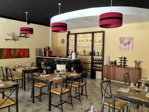 a restaurant with tables and chairs and a bar at For Rest Aparthotel in St Paul's Bay