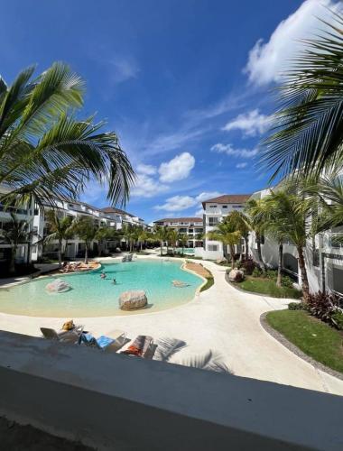 a pool at a resort with palm trees at Estrella Izha 204 in La Laguna