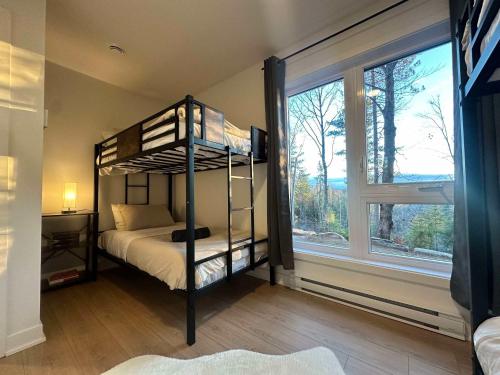 a bedroom with a bunk bed and a large window at Foosball table Spa & Sauna - Sommetoile in Saint Come