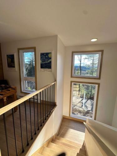a staircase with three windows in a house at Foosball table Spa & Sauna - Sommetoile in Saint Come