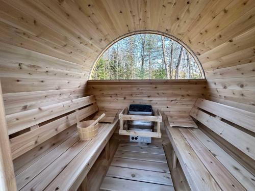 an inside of a wooden sauna with a window at Foosball table Spa & Sauna - Sommetoile in Saint Come