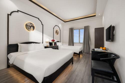 Postel nebo postele na pokoji v ubytování Golden Glow Hue City