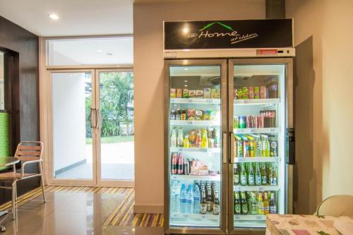 a refrigerator filled with lots of drinks in a restaurant at At Home at Udon in Udon Thani