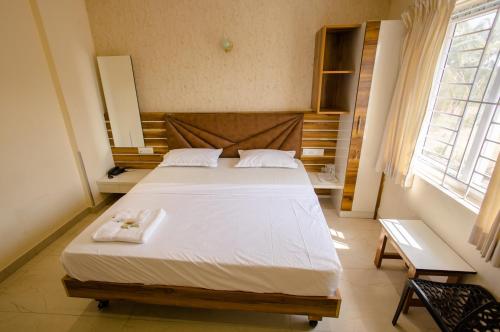 Postel nebo postele na pokoji v ubytování Parva Residency