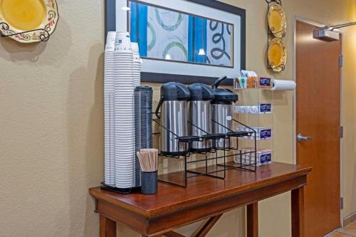 a table with plates and cups on top of it at Best Western Plus Guymon Hotel and Suites in Guymon