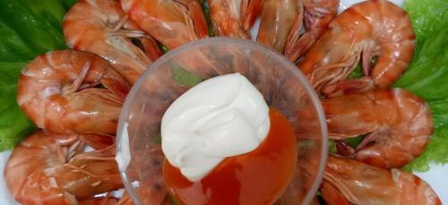 a plate of shrimp with a tablespoon of mayonnaise on top at Green Hotel Da Nang in Da Nang