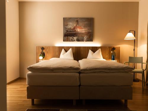 a bedroom with a bed with white pillows on it at At the Park Hotel in Baden