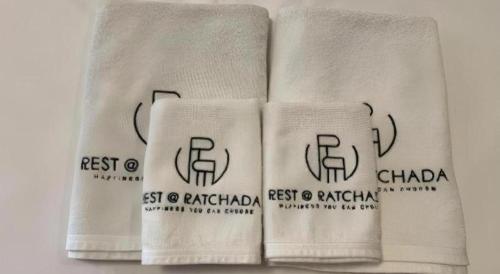 three white towels with the words best of patagonia on them at Rest@Ratchada hotel in Bangkok
