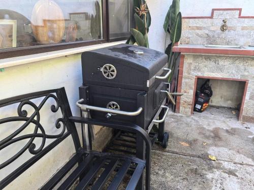 a stove sitting on a bench next to a fireplace at Харизма in Hisarya