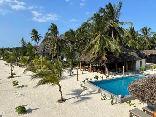 an aerial view of a resort with a swimming pool at Pamoja Villas in Migogoni
