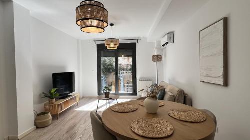 a living room with a table and a tv at Apartamenticos Living San Pablo in Zaragoza