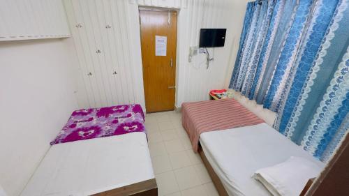 Postel nebo postele na pokoji v ubytování Hotel Panthapath Near Square Hospital