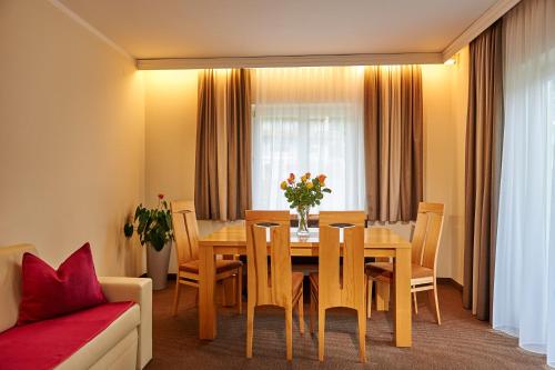 a dining room with a wooden table and chairs at Apartment Panorama in Wagrain